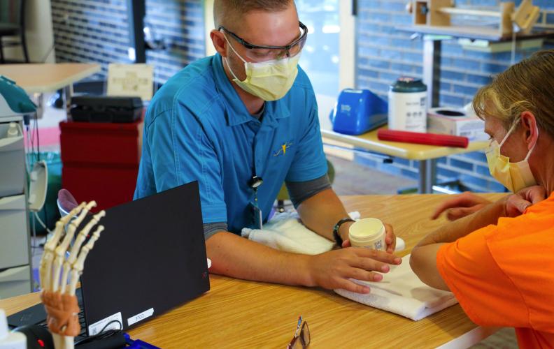 ALIVE employee signing a person into the building