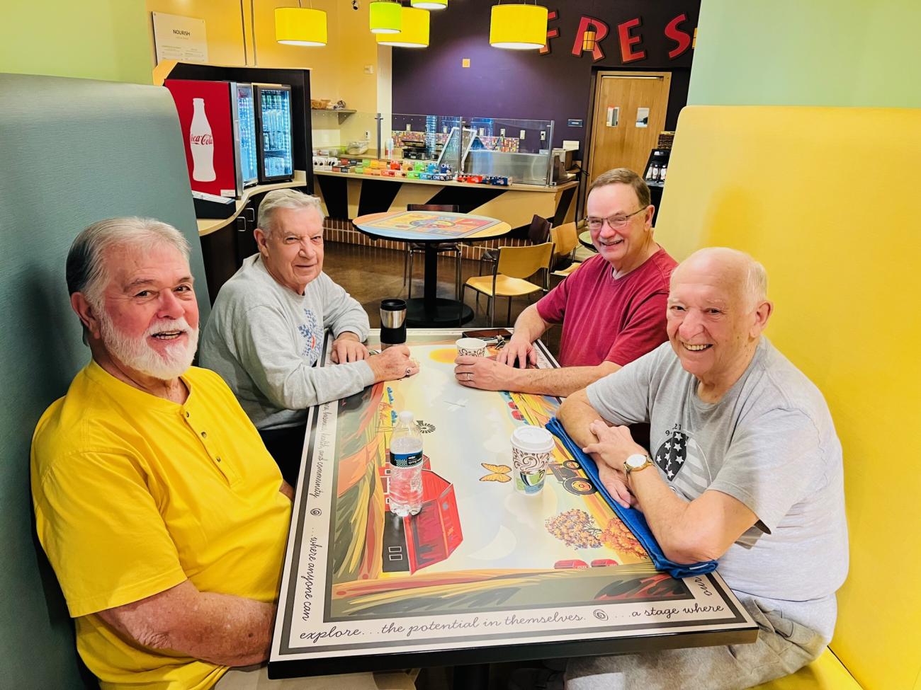 men in a booth at the cafeteria